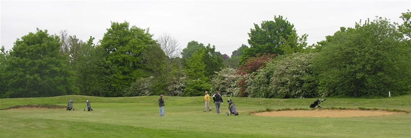 Golfers avoiding the bunkers at Oxhey Park, near Watford, Herts 