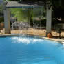 Waterfall feature at edge of swimming pool